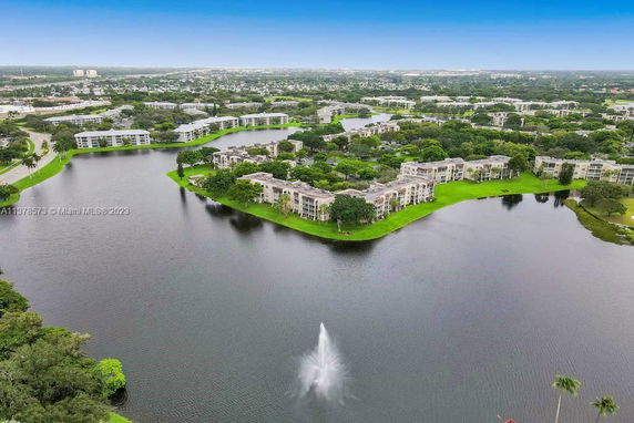 Aerial panoramic view of residential buildings surrounding a body of water.