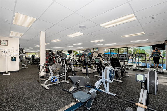 Gym interior with exercise machines and equipment.