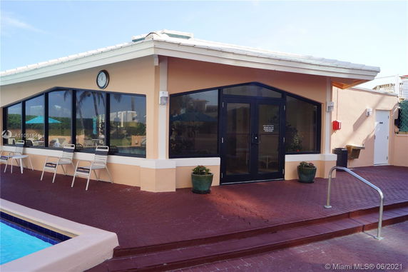 Outdoor view of a building by a swimming pool.