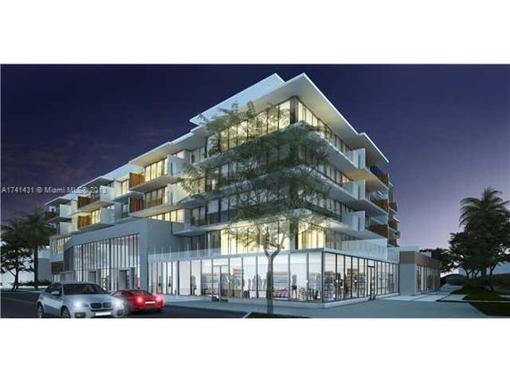 Front view of a multi-story modern building with large windows and balconies.