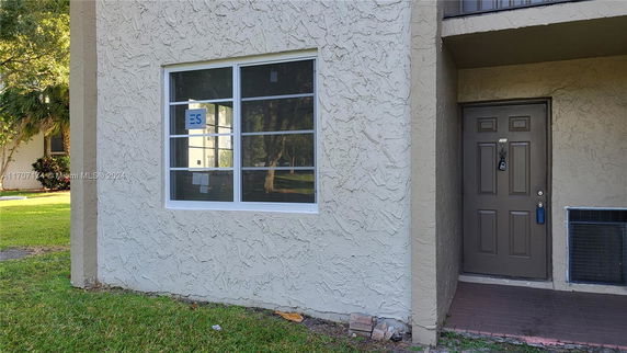 Front view of a building entrance with a door and window.