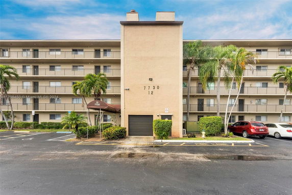 Front view of a multi-story apartment building with balconies.
