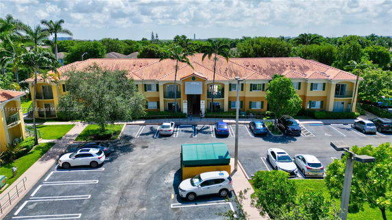 Front view of a residential building with a parking area.