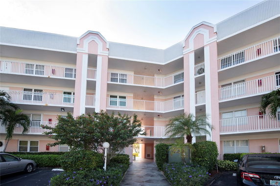Front view of a multi-story residential building with balconies.