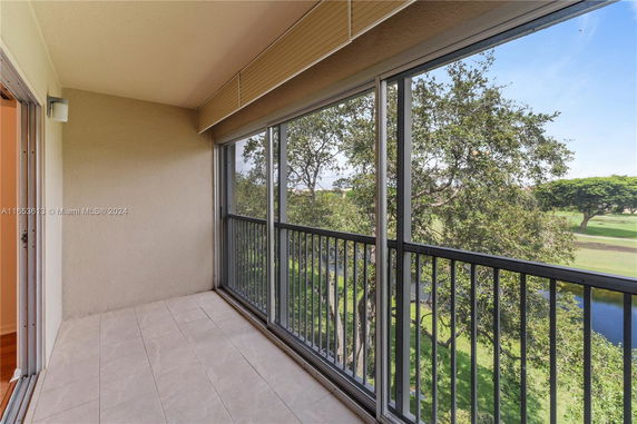 View from a balcony overlooking trees and greenery.