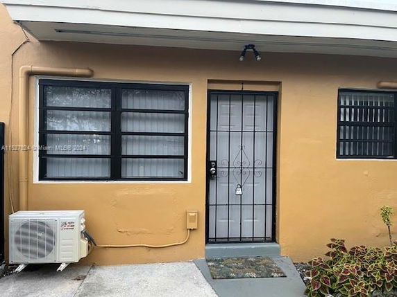Front view of a single-story house with barred windows and a door.