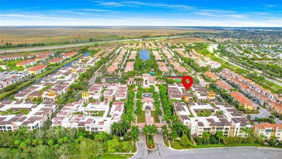 Panoramic view of a residential area with multiple buildings and a central garden.