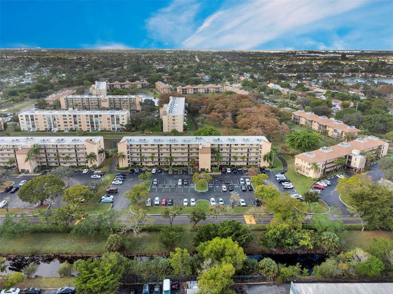 Panoramic view of residential buildings surrounded by trees and roads.