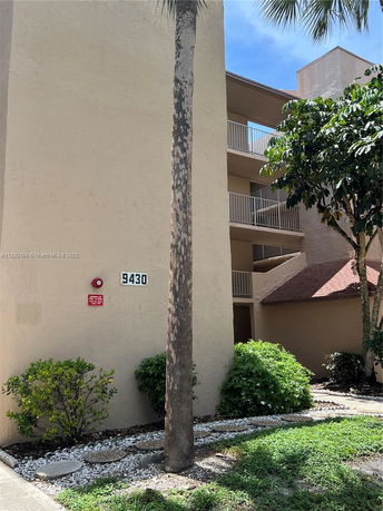 Side view of a multi-story building with balconies.