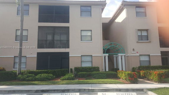 Front view of a multi-story residential building with a central entrance.