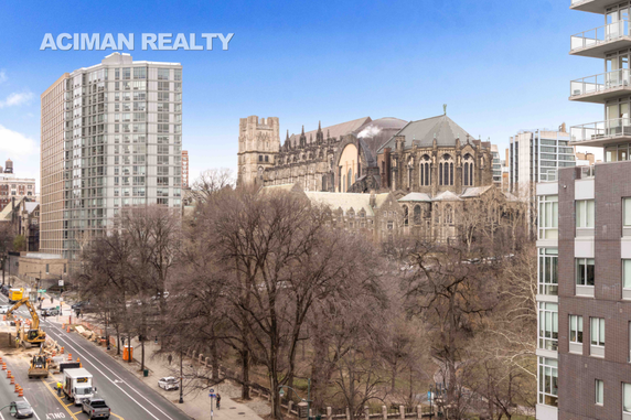 View of a cityscape with a mix of modern buildings and a historic cathedral.