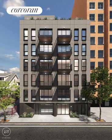 Front view of a multi-story apartment building with balconies and large windows.