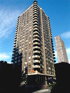 Front view of a high-rise residential building with balconies.