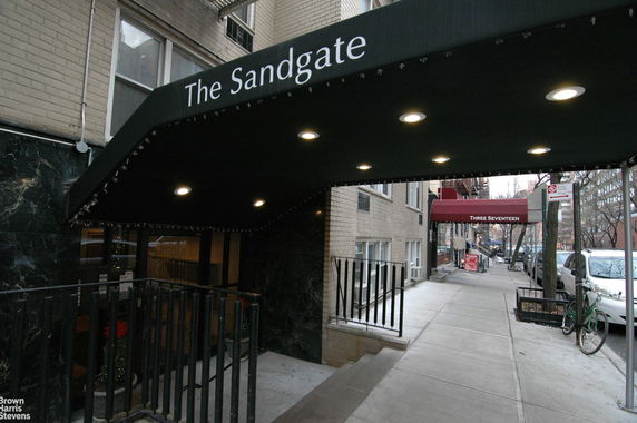 Front view of a multi-story building entrance with an awning labeled 'The Sandgate'.
