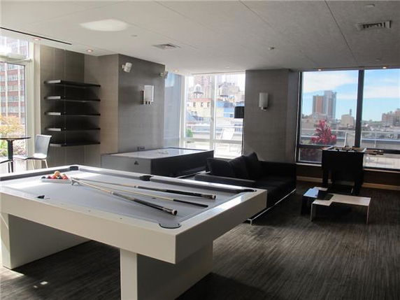 Room with a pool table and seating area.