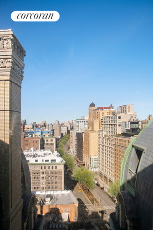 Panoramic view of a cityscape with tall buildings and a clear blue sky.