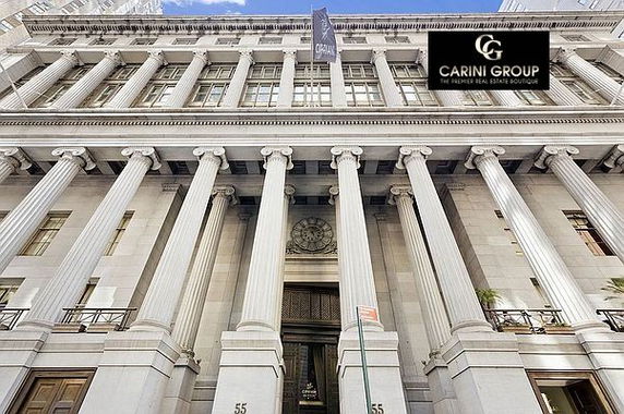 Front view of a grand multi-story building with large columns and classical architecture.