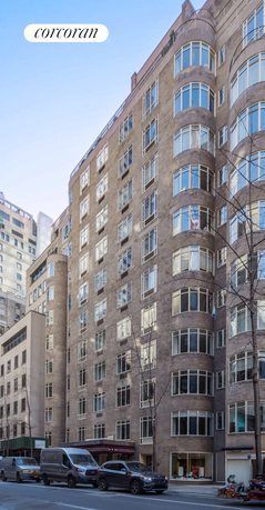 Front view of a multi-story residential building with large windows.