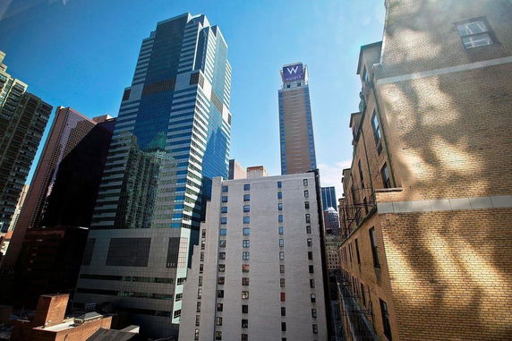 View of tall buildings in a cityscape, including a high-rise hotel and several other skyscrapers.