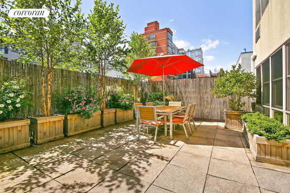 Rooftop with potted plants, outdoor dining table, and red umbrella.