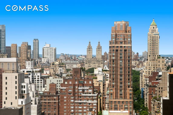 Panoramic view of a cityscape dominated by numerous tall buildings.