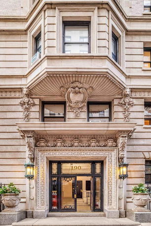 Front view of a building with ornate architectural details, including decorative stonework around the entrance.