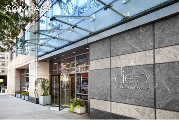 Facade of a building with glass entrance and modern design elements.