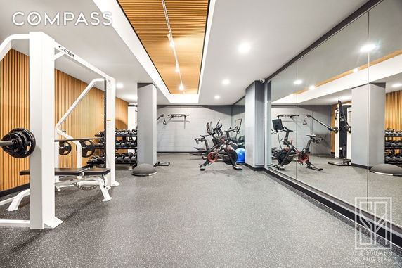 Gym area with exercise equipment and weights.