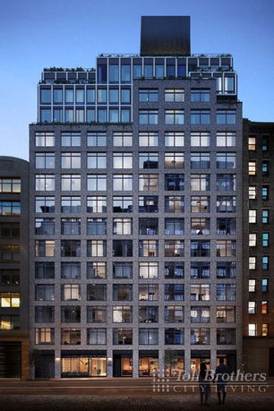 Front view of a multi-story apartment building with a modern design and large windows.