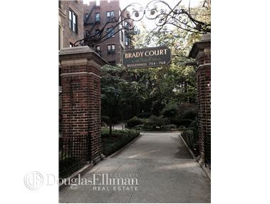 Entrance view of a residential complex with a sign reading 'Brady Court'.