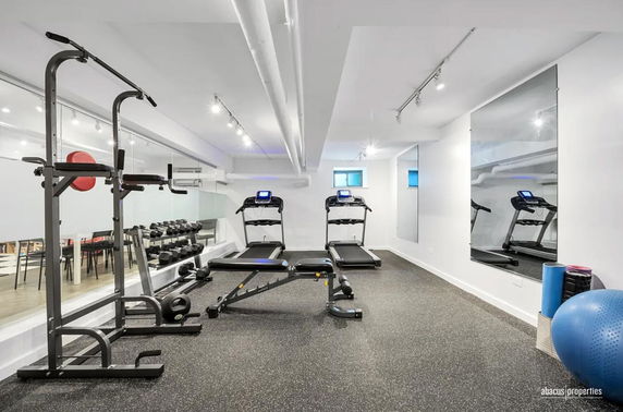 Indoor gym area with treadmills and exercise equipment.