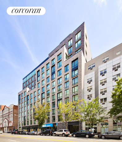 Front view of a modern multi-story building with numerous windows.