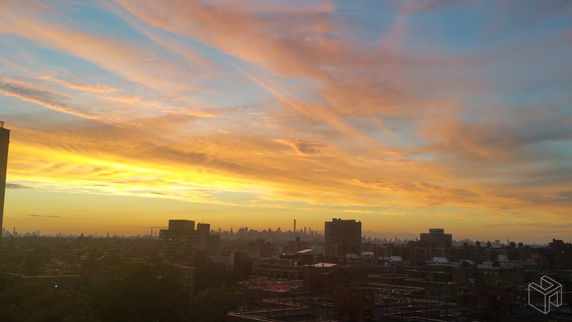 Panoramic view of a city skyline with a dramatic sunset.