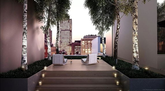 Stylish rooftop with wooden deck, seating area, and city skyline view.
