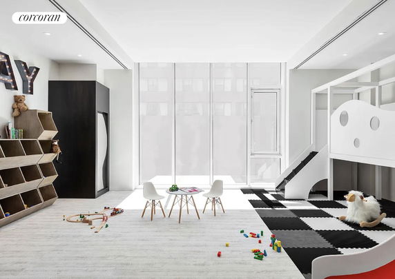 Children's indoor play area with toys and small furniture.