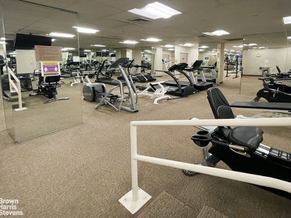 Interior view of a gym with various exercise equipment.