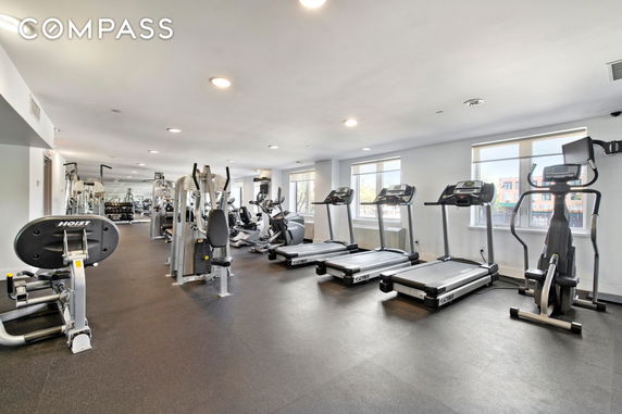 Interior view of a gym with exercise equipment and treadmills.