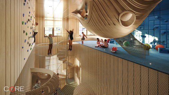 Interior view of a modern indoor play area for children with climbing walls and playful structures.