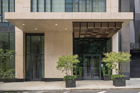 Front elevation of a modern building with large glass doors and windows.