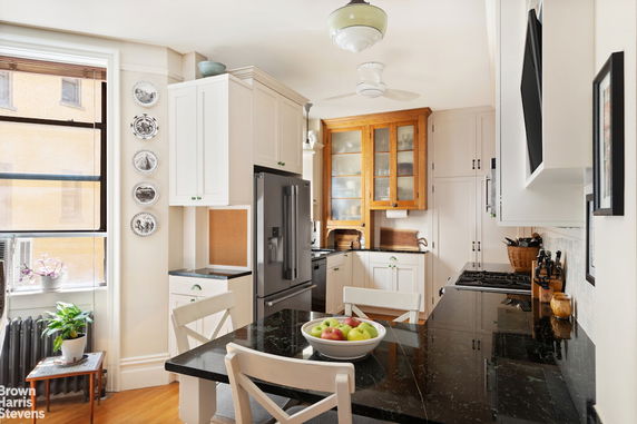 Front view of a house with a sloped roof and large windows.