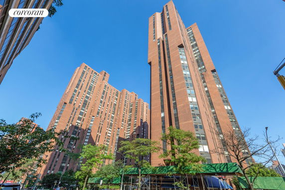 Front view of multiple high-rise residential buildings with brick façades.