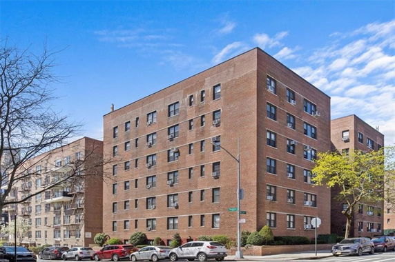 Front view of a multi-story brick apartment building.