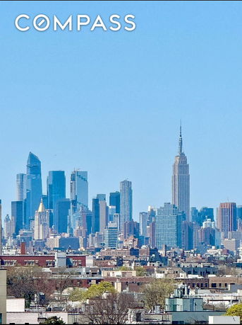 Panoramic view of a city skyline with prominent skyscrapers.
