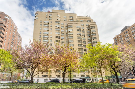 Front view of a multi-story apartment building with numerous windows.