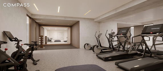 Indoor gym area with exercise equipment including treadmills and stationary bikes.