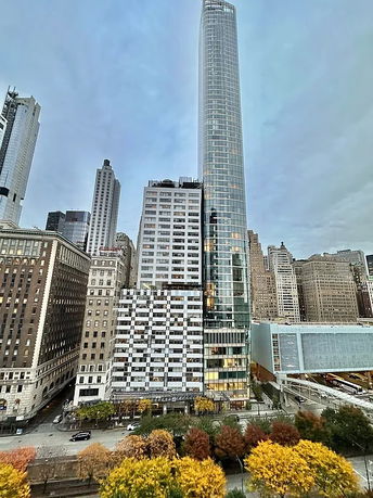 Front view of a modern high-rise building in a cityscape.