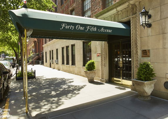 Front view of a building entrance with a green awning displaying the address Forty One Fifth Avenue.