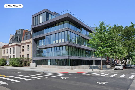 Front view of a modern multi-story building with extensive glass windows.