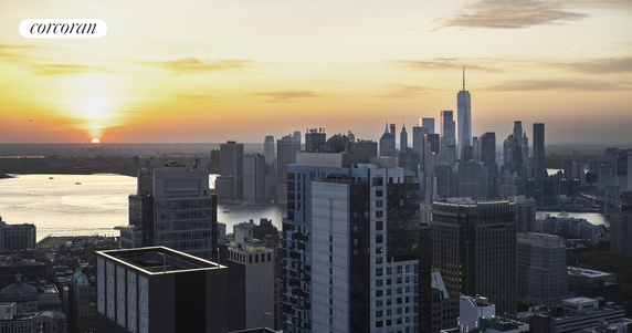 Skyline view of a city with tall buildings at sunset.