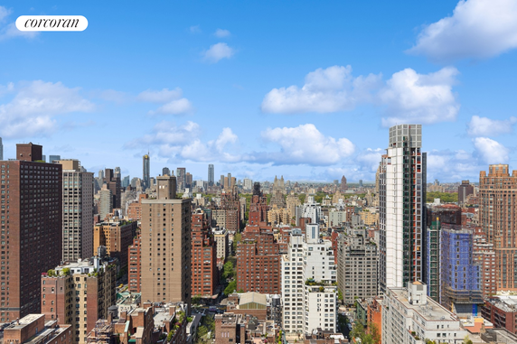 Panoramic view of a city's skyline with numerous high-rise buildings.